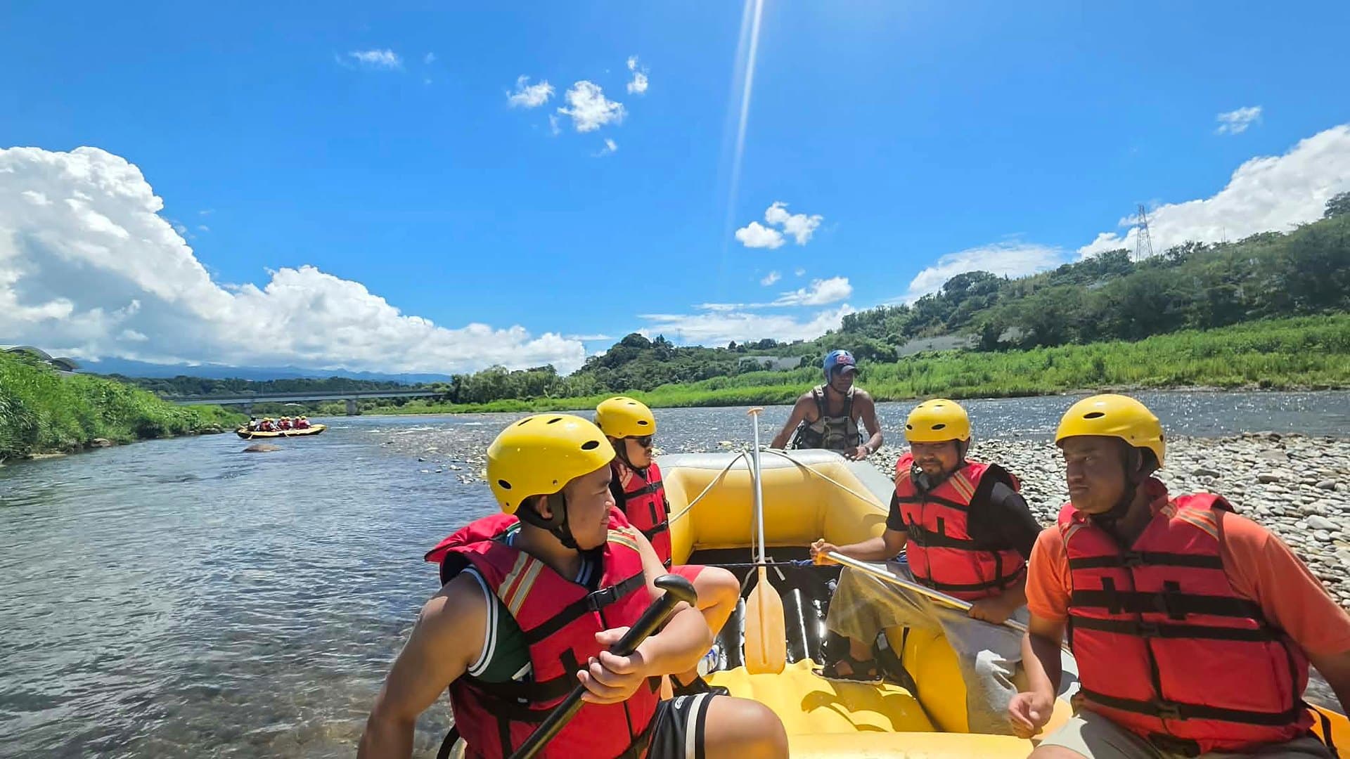 Guests paddling a Dream Adventure raft down the Tone River in Numata, Gunma